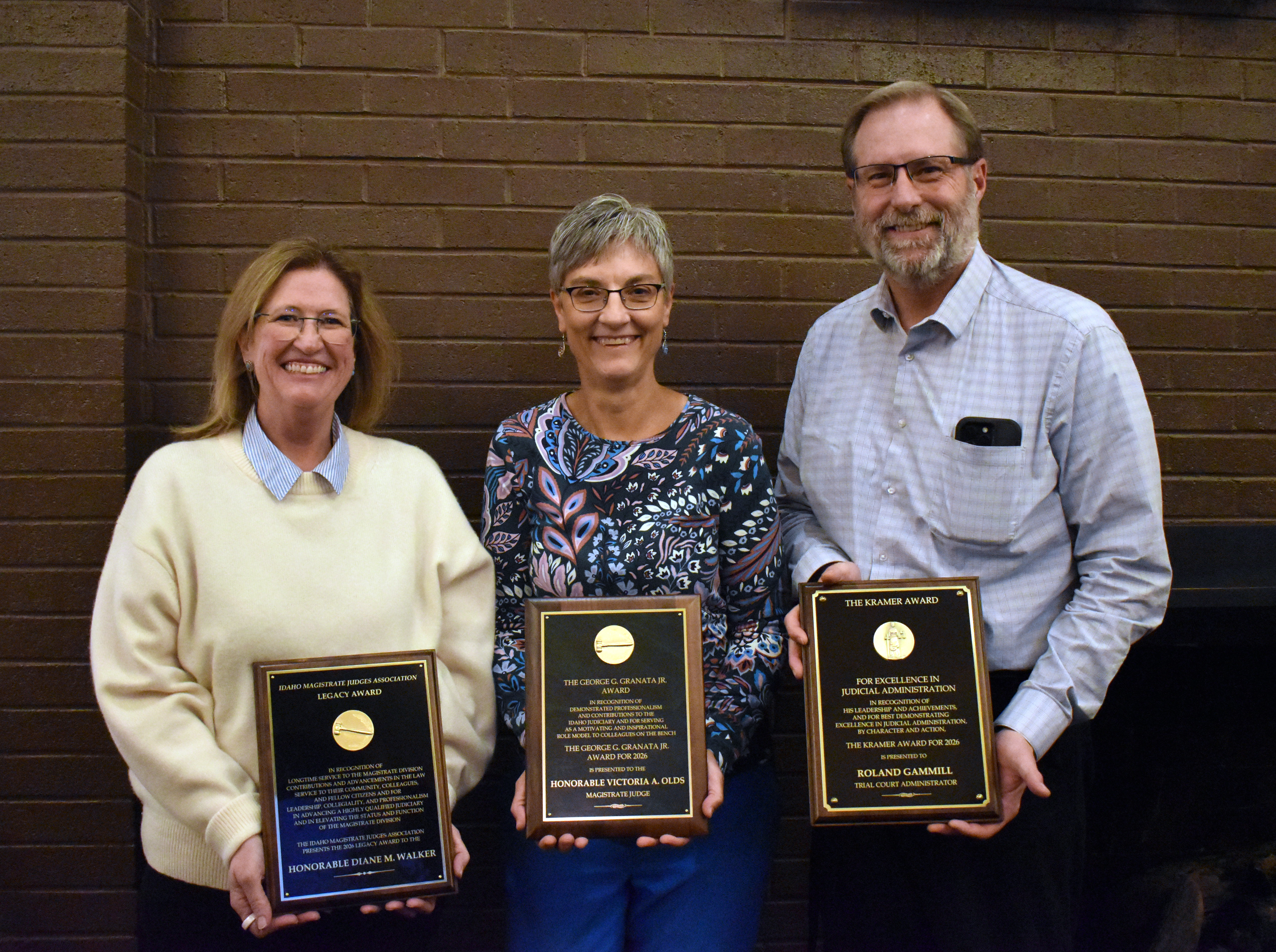 Judge Diane Walker, Judge Victoria Olds, and Trial Court Administrator Roland Gammill stand with their awards.